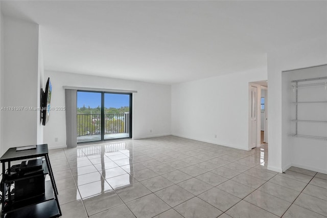 interior space with light tile patterned floors and baseboards