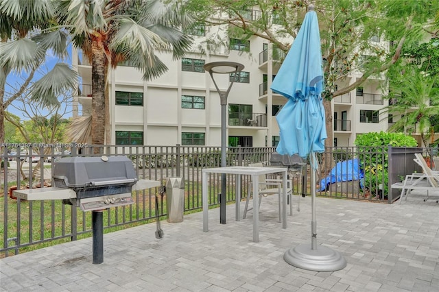 view of patio featuring area for grilling and fence