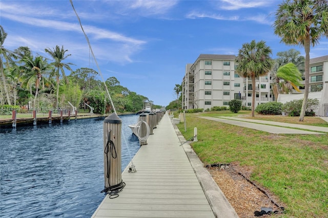 dock area with a yard and a water view