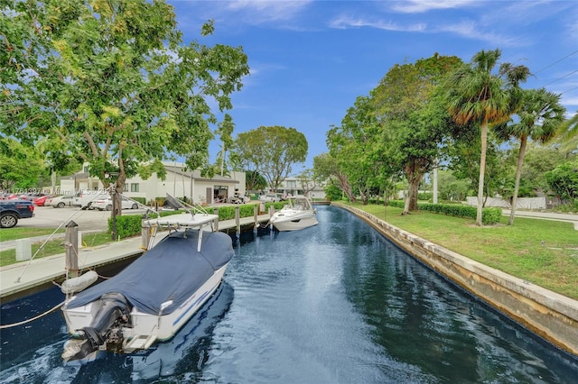 exterior space with a boat dock, a yard, and a water view