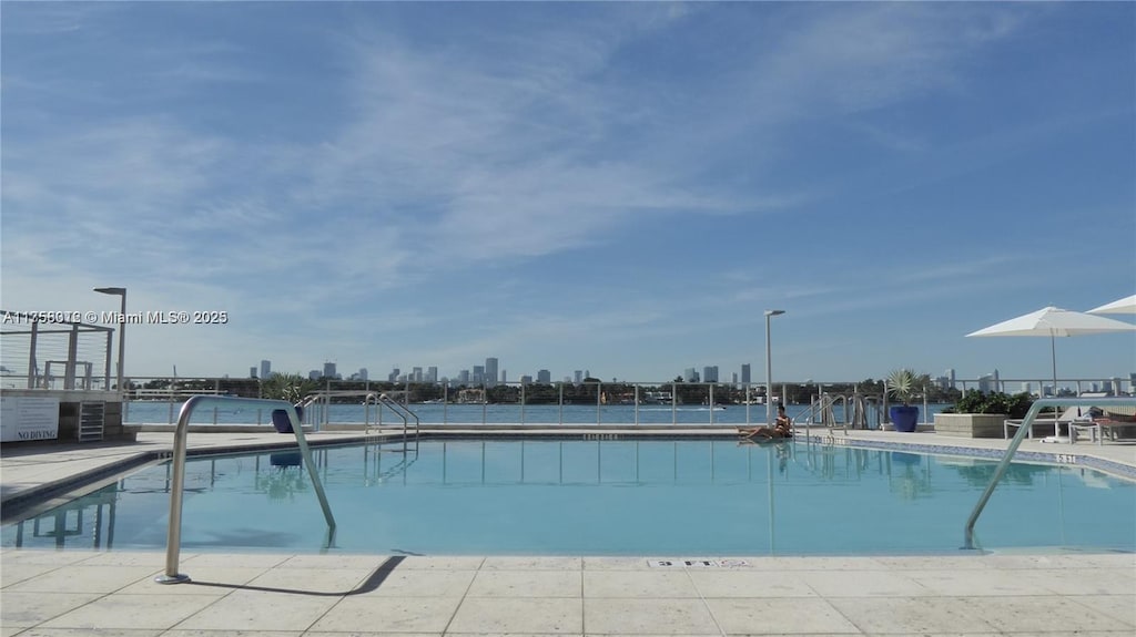 view of pool with a city view