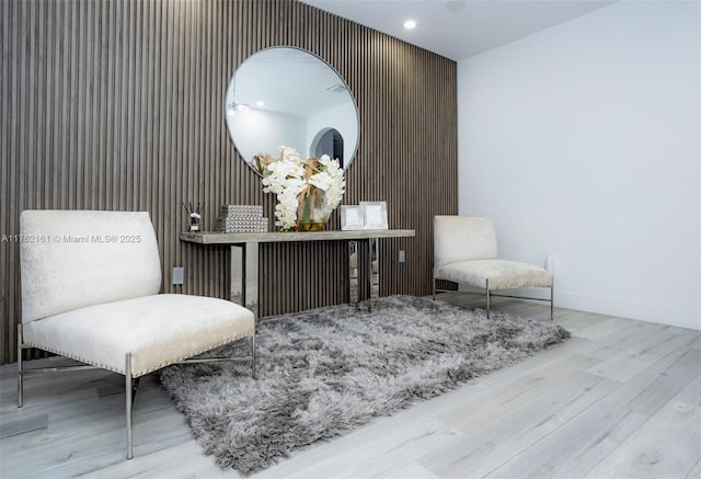 living area featuring recessed lighting, wood finished floors, and baseboards