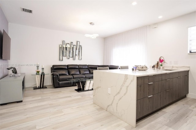 interior space with light wood finished floors and visible vents