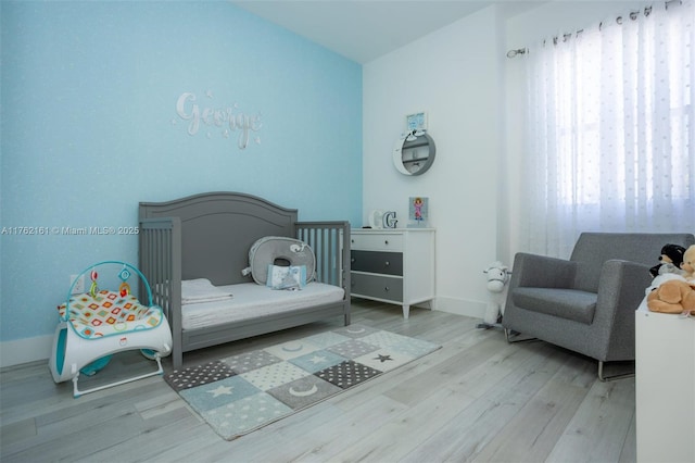 bedroom featuring baseboards and wood finished floors