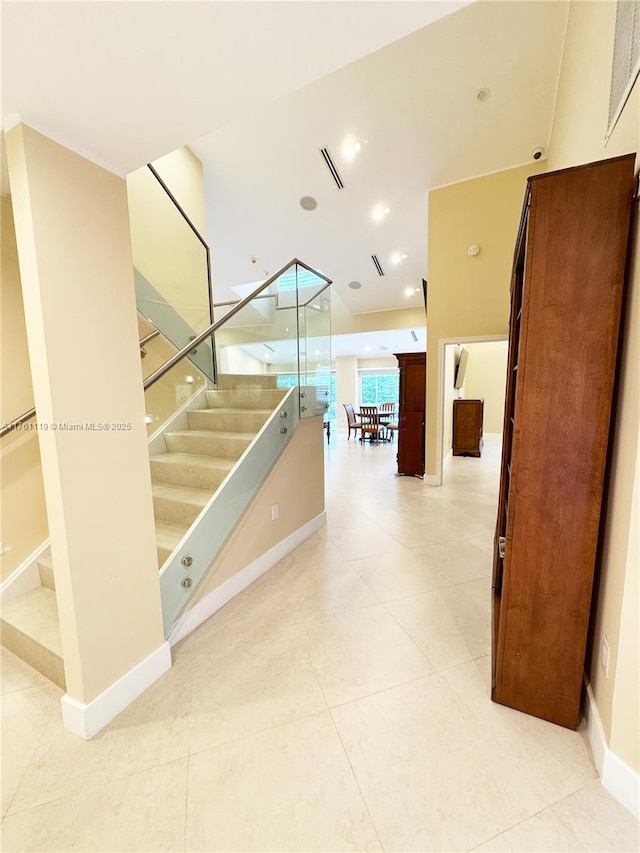 stairs with tile patterned floors, recessed lighting, baseboards, and visible vents