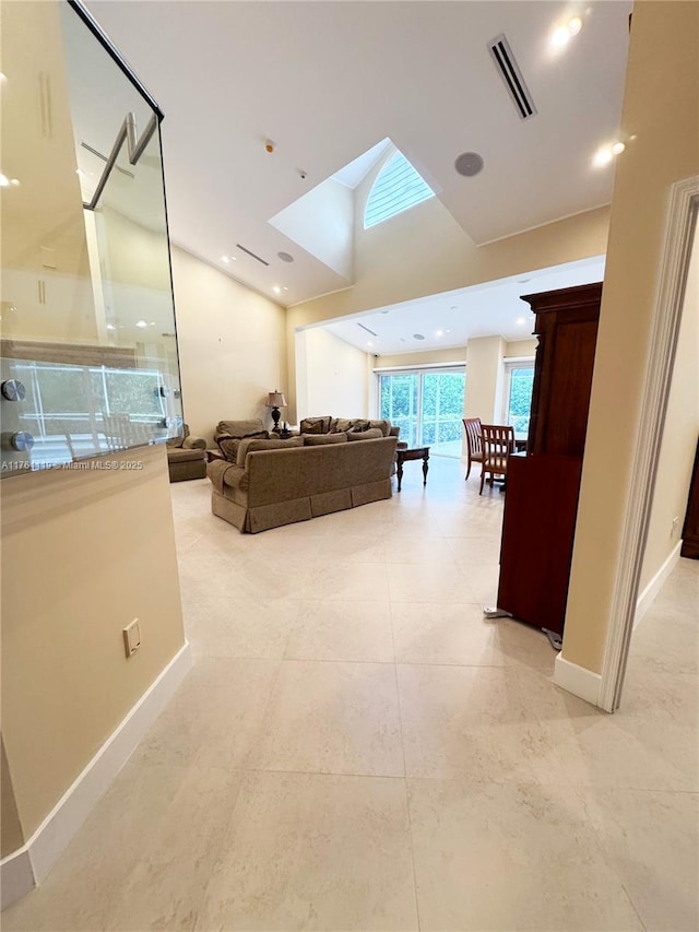 hallway with vaulted ceiling, recessed lighting, baseboards, and visible vents