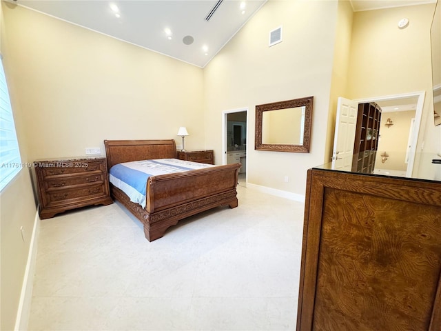 bedroom featuring visible vents, baseboards, high vaulted ceiling, and connected bathroom