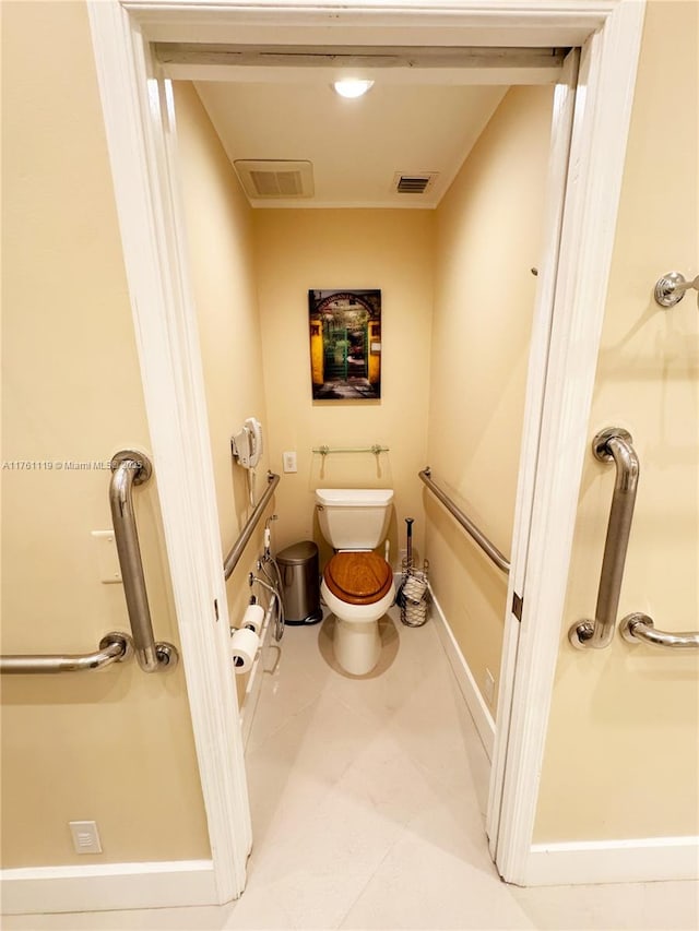 bathroom with toilet, baseboards, and visible vents