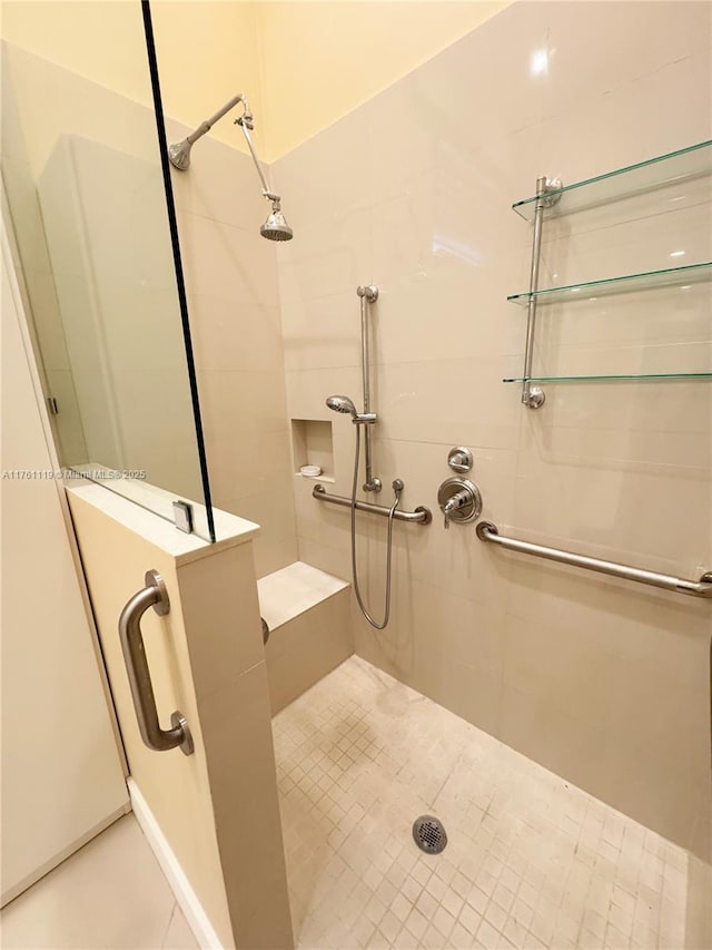 bathroom featuring tile patterned flooring and a stall shower