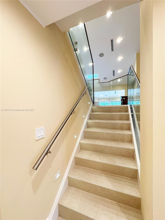 stairway with tile patterned floors and visible vents