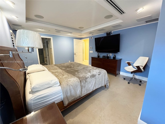 bedroom featuring visible vents, baseboards, and a tray ceiling