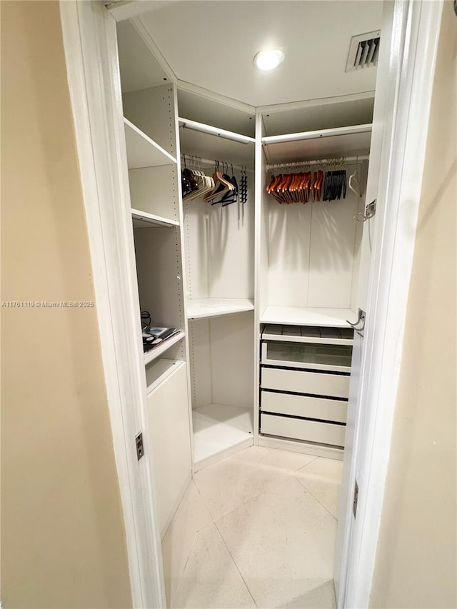 walk in closet with tile patterned floors and visible vents