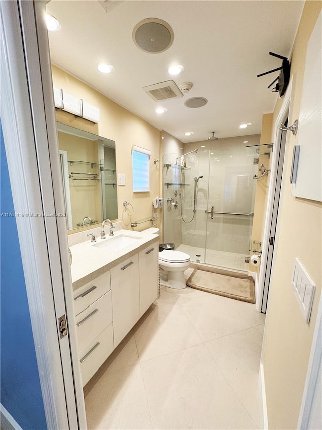 bathroom with toilet, a stall shower, recessed lighting, tile patterned flooring, and vanity