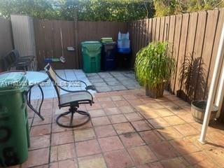 view of patio featuring fence