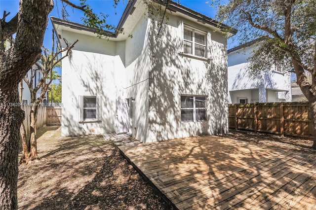 rear view of house with a deck and a fenced backyard