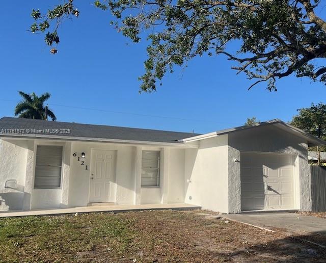 single story home with stucco siding and a garage