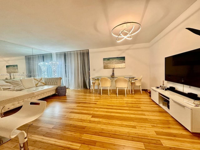 living room featuring a chandelier and light wood-type flooring