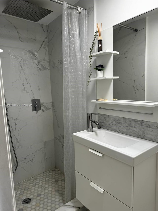 bathroom featuring decorative backsplash, a shower stall, and vanity