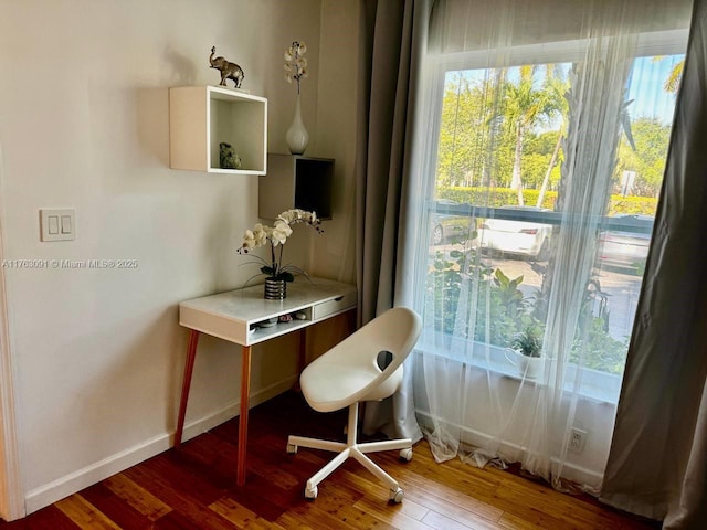 office space with baseboards and wood finished floors