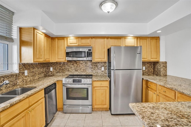 kitchen featuring light tile patterned floors, stainless steel appliances, tasteful backsplash, and light stone countertops