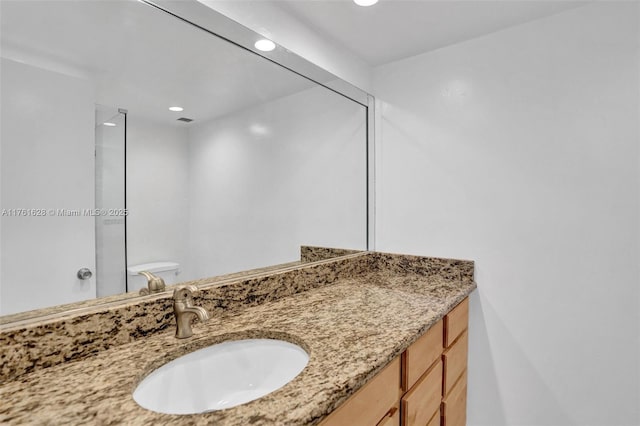 bathroom with recessed lighting and vanity