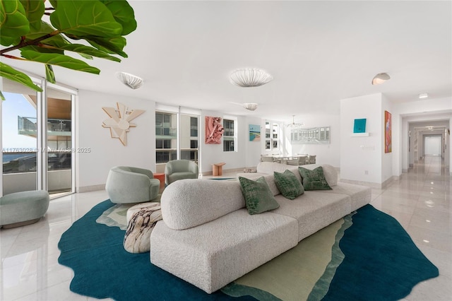 living room featuring light tile patterned floors and baseboards