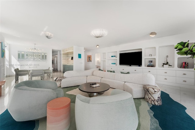 living area featuring a notable chandelier and built in shelves