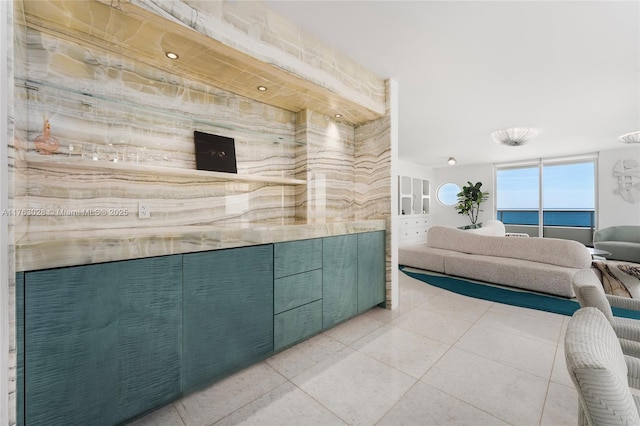 interior space with tile patterned floors and ensuite bathroom