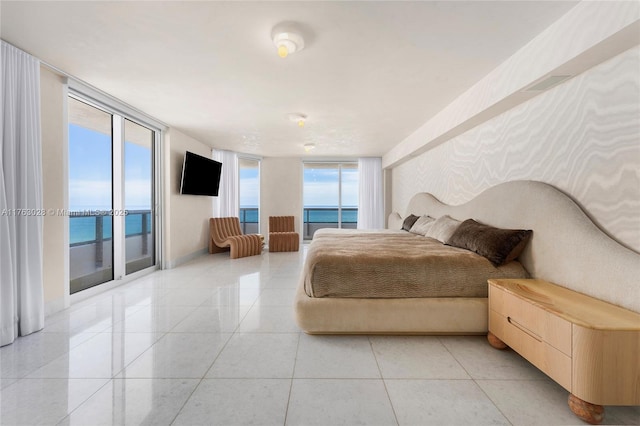 bedroom featuring light tile patterned floors, floor to ceiling windows, and access to outside