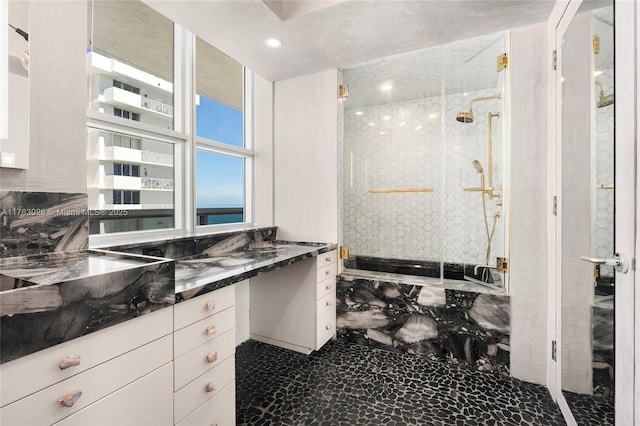 bathroom with recessed lighting, a stall shower, and vanity