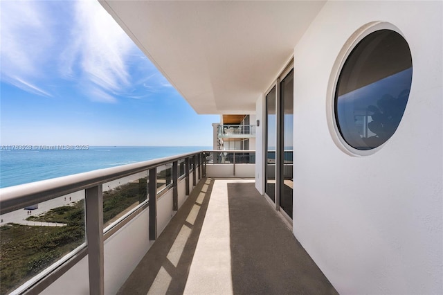 balcony with a beach view and a water view