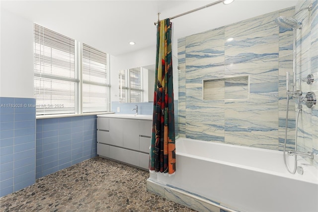 full bath with recessed lighting, shower / tub combo with curtain, tile walls, and vanity