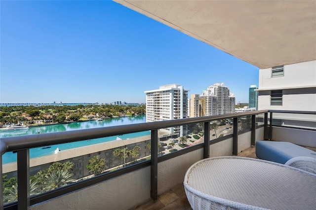 balcony with a view of city and a water view