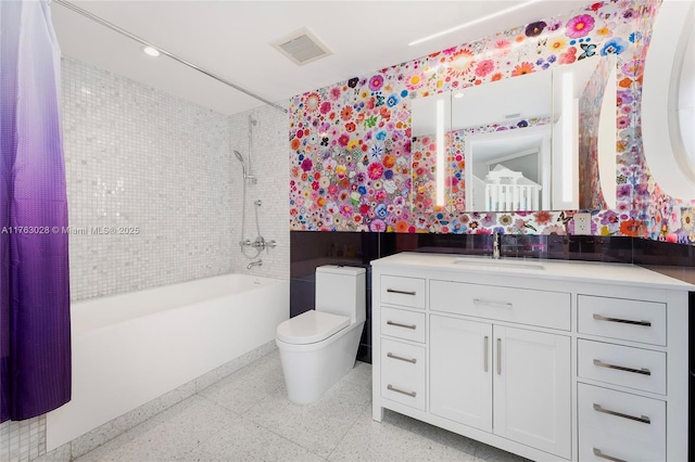 full bath with visible vents, vanity, toilet, and shower / tub combination