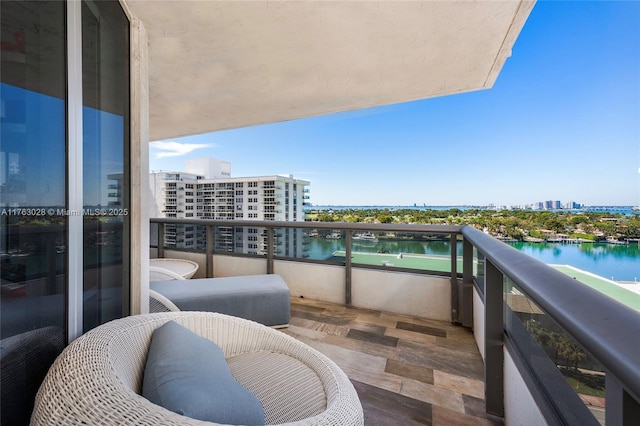 balcony featuring a city view and a water view