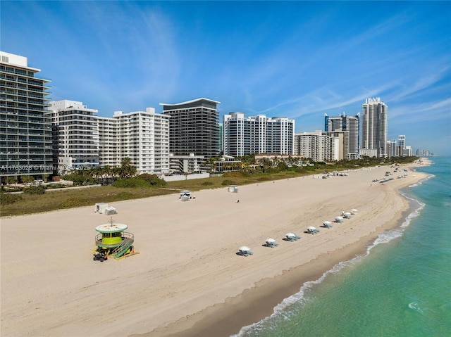 birds eye view of property with a view of city, a beach view, and a water view