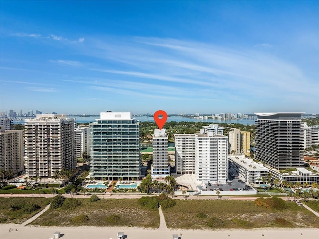 birds eye view of property with a view of city and a water view