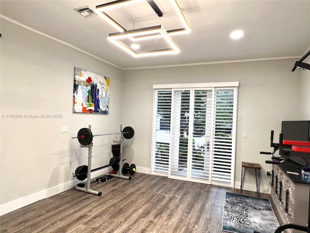 workout room with visible vents, wood finished floors, baseboards, and ornamental molding