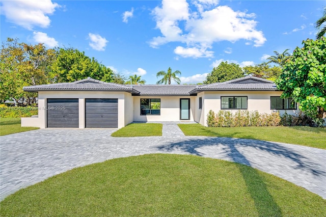 ranch-style home with a tiled roof, a front lawn, decorative driveway, and a garage