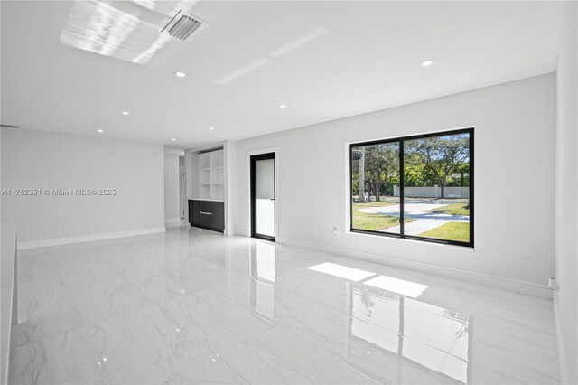 unfurnished living room with visible vents, recessed lighting, marble finish floor, and baseboards