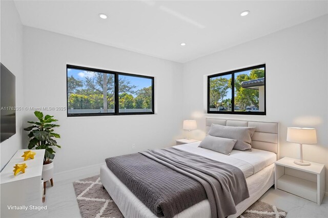 bedroom featuring recessed lighting, multiple windows, and baseboards