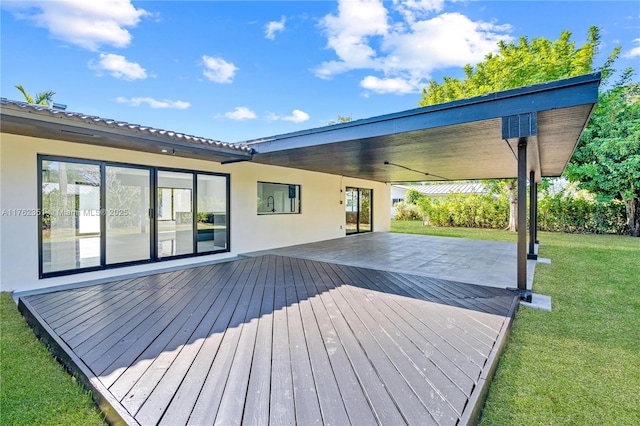 wooden deck featuring a lawn