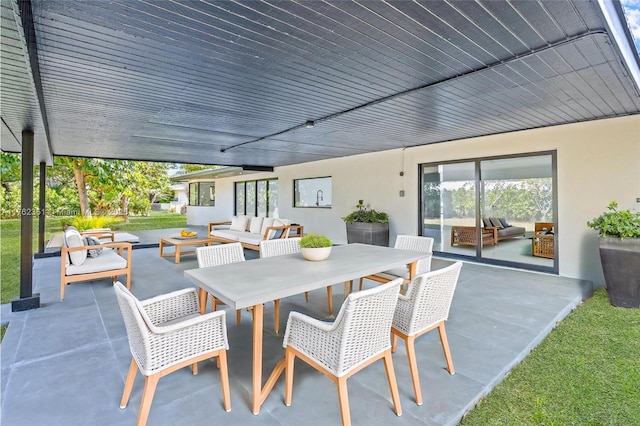 view of patio / terrace with outdoor dining space and an outdoor hangout area