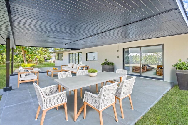 view of patio / terrace with outdoor dining space and an outdoor hangout area