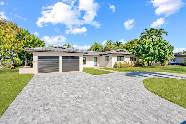 view of front of home with a garage, stucco siding, decorative driveway, and a front yard