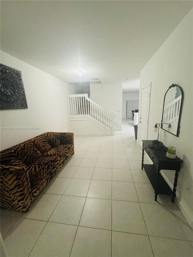 hall with light tile patterned floors