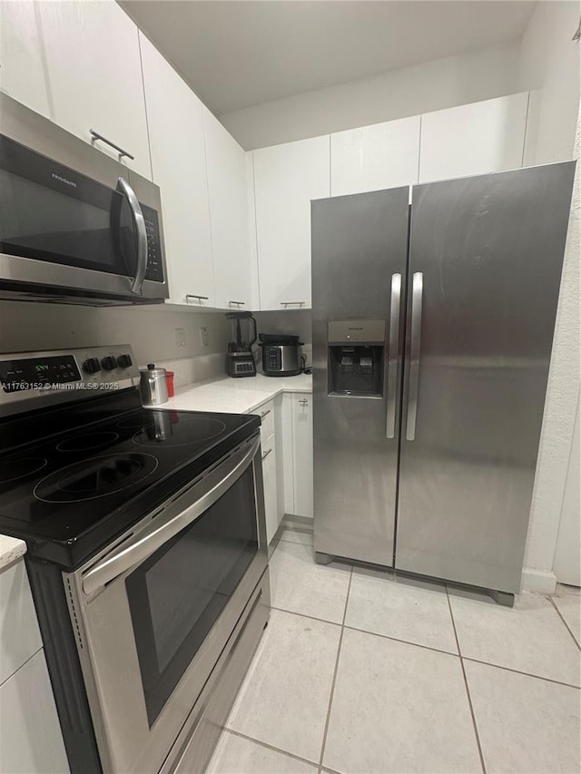 kitchen featuring white cabinetry, light countertops, and appliances with stainless steel finishes