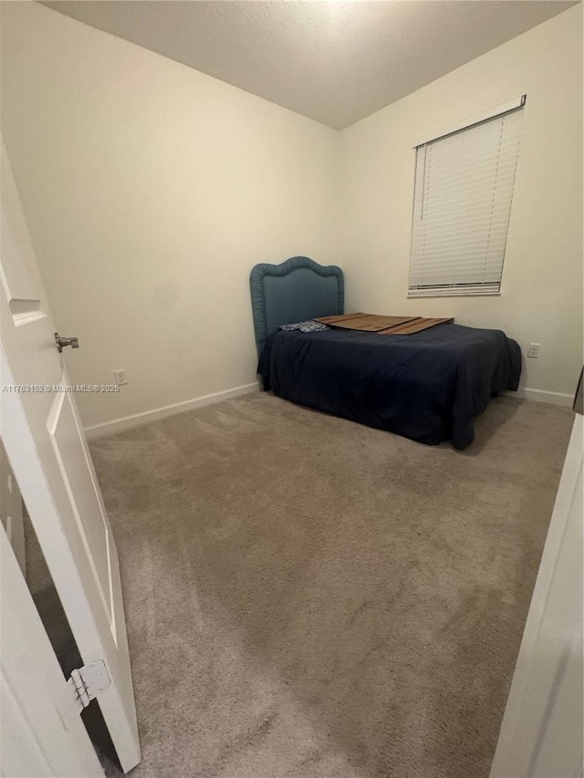 carpeted bedroom with baseboards