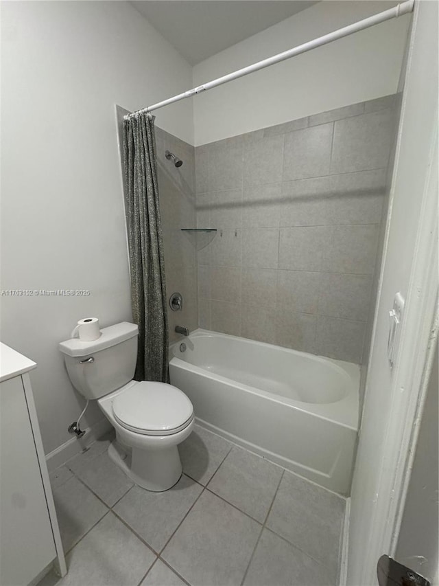 bathroom with baseboards, toilet, shower / tub combo with curtain, tile patterned floors, and vanity