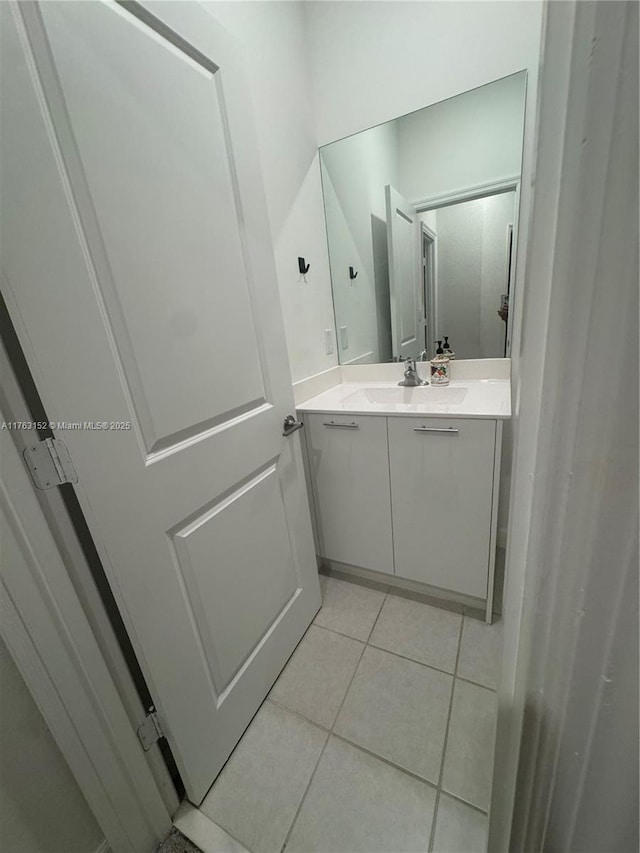 bathroom featuring tile patterned flooring and vanity